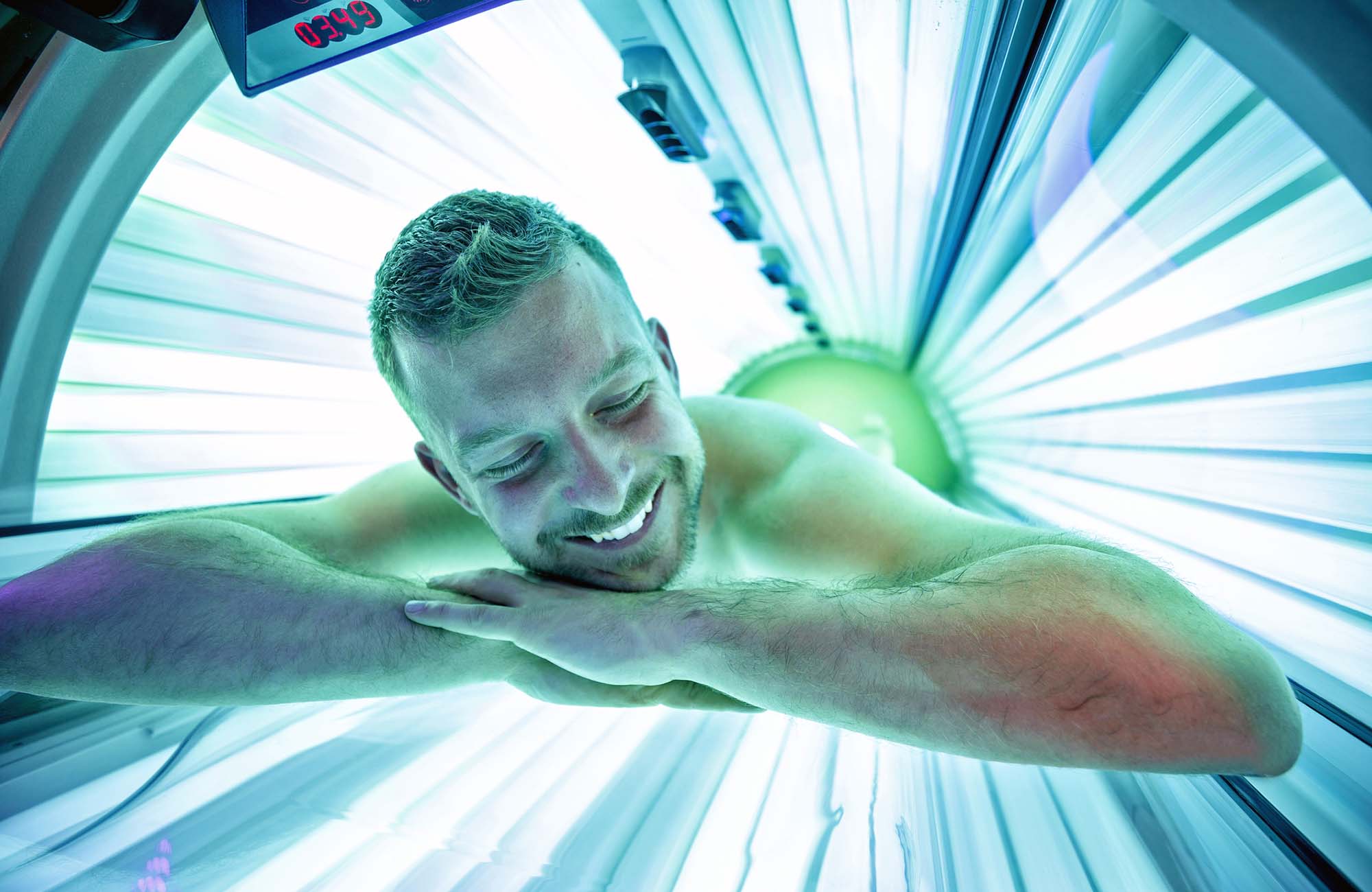 Man in sunbed relaxing and enjoying while getting a tan